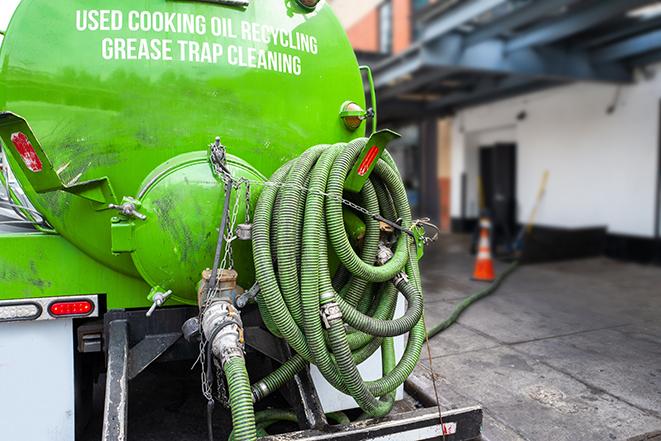 a technician pumping a grease trap in a commercial building in Unionville, TN